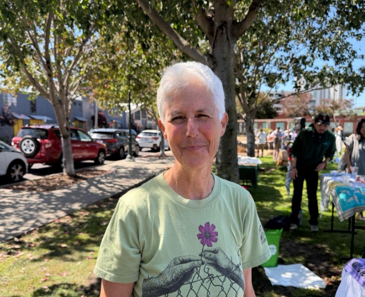 Portrait of an old lady with silver short hair and green t-shirt